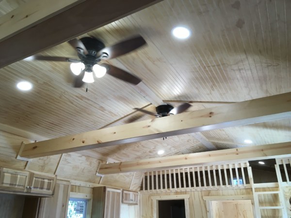 Finished Lofted Side Porch Cabin Interior with Custom Loft Sizes and Wrapped Beams