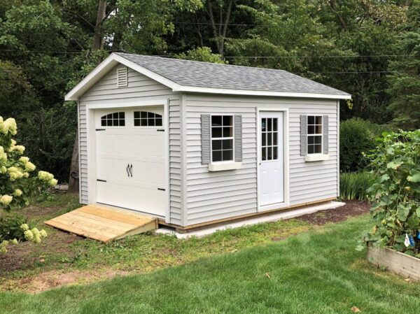 How do Rent to Own Cabins & Sheds Work? 7 12x16 GCG Sterling Gray Vinyl Estate Gray Shingles 9x7 OH Decorative door 9lite door 2x3 windows white flower boxes gray shutters 4x8 ramp 12inch overhangs Peter Konz 4 scaled e1636555557429